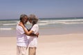 Senior couple head to head and embracing each other on beach Royalty Free Stock Photo