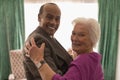 Side view of happy senior couple looking at camera while dancing Royalty Free Stock Photo