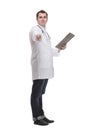Side view of happy smiling mature doctor with stethoscope around the neck writing on clipboard Royalty Free Stock Photo