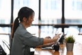 Happy young female designer pointing on screen of digital tablet. Royalty Free Stock Photo