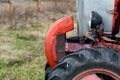 Side view of headlamp on old vintage red rusty tractor sharp focus details well kept machine autumn outdoor rural view Royalty Free Stock Photo