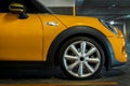 Side view of Headlights, Wheel, Hood, Sidelights and Side view mirror of Yellow car