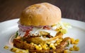 Side view of a healthy egg burger with mayo, corn, potato wedges and more Royalty Free Stock Photo