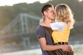 side view of heterosexual couple going to kiss on river beach Royalty Free Stock Photo