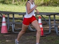 Girl running in a cross country race passing a picnic table Royalty Free Stock Photo