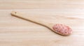 Side view of Himalayan pink salt on a wood spoon