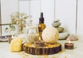 Side view of home wellness spa products, orange bath bomb, aroma bath salt, sea sponge, tea candles lit. Royalty Free Stock Photo