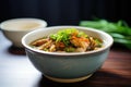 side view of hot and sour soup in a ceramic bowl