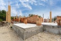 Side view of house support elements and new brick wall. Beginning of the construction residential building with wooden and Royalty Free Stock Photo