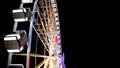 Side view of huge Ferris wheel rotating at amusement park under dark night sky Royalty Free Stock Photo