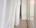 Side view of a huge panoramic window with a transparent white curtain, modern interior of apartments in a luxury hotel