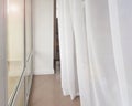 Side view of a huge panoramic window with a transparent white curtain, modern interior of apartments in a luxury hotel