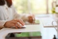 Side view image of a businesswoman working at her desk, using wireless mouse Royalty Free Stock Photo