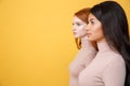 Side view image of concentrated young two ladies Royalty Free Stock Photo