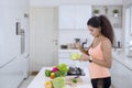 Indian woman eats fresh salad in the kitchen Royalty Free Stock Photo