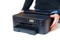Side View of Inkjet Printer in Hands on White Background