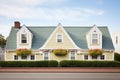 side view of an ivycovered cape cod with symmetrical dormers