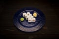 Japanese sushi roll with salmon, cream cheese on dark blue glass plate and wooden background