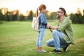 Side view of joyful young father smiling while holding daughter's hands, daddy spending time with his little girl in the Royalty Free Stock Photo