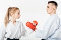 side view of karate fighters touching with gloves