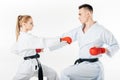 side view of karate fighters training in kimono and red gloves