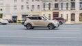 Side view of Kia Soul car in motion. Beige compact hatchback moving on the street on high speed Royalty Free Stock Photo