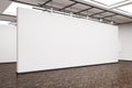 Side view of a large blank wall in an art gallery with dark wood Royalty Free Stock Photo