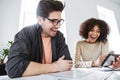 Side view of laughing young colleagues having fun together