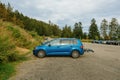 Side view at the lava blue colored Volkswagen Touran van with bike carriage