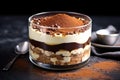 side view of a layered tiramisu in a glass dish