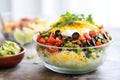 side view of a layered veggie burrito bowl