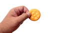 Male hand holding round cracker cookie isolated on white background Royalty Free Stock Photo