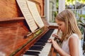 Talented little girl playing piano in modern living room