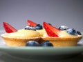 Crusty French tarts filled with custard cream and fresh berries