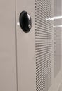 Side view of a locker with mesh grid and a black safety plate holder for a key. Royalty Free Stock Photo