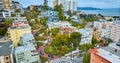 Side view Lombard Street with aerial of San Francisco Bay and residential buildings