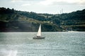 Sailing boat on blue water of harbor Royalty Free Stock Photo