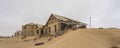 Side view with lot of sand to the Lehrer house at German Kolmanskop Ghost Town with the abandoned buildings