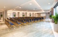 Side view of luxury auditorium interior with empty white screen and vintage blue seats. Modern conference hall background Royalty Free Stock Photo