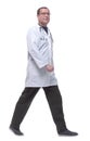 Side view. male doctor with a stethoscope confidently walking forward. Royalty Free Stock Photo