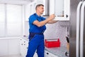 Handyman Fitting Cabinet Door Royalty Free Stock Photo