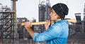 Side view of male hipster holding axe against factory Royalty Free Stock Photo