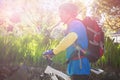 Side view of male mountain biker with bicycle in forest Royalty Free Stock Photo