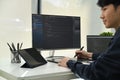 Side view of male programmer working on laptop to check coding in bugging system in IT office Royalty Free Stock Photo