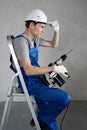 Side View of Male Worker with Puncher in Hands Royalty Free Stock Photo