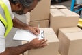 Male worker writing on clipboard in warehouse Royalty Free Stock Photo