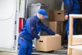 Side View Of A Man Carrying Cardboard Box Royalty Free Stock Photo