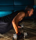 Side view of a man doing plank with metal dumbbells Royalty Free Stock Photo