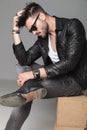 Side view of man in leather jacket sitting and thinking Royalty Free Stock Photo