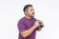 Side view of a man looking confused upon seeing something mysterious with his binoculars. Speechless and dumbstruck expression. Royalty Free Stock Photo